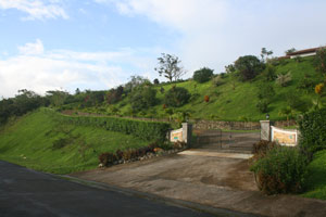 The entrance gate is immediately beside the paved lake highway.